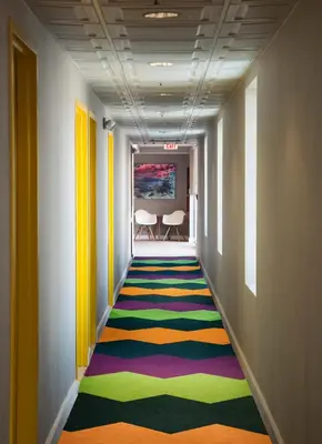 a hallway with a colorful rug on the floor at The Kinney - Venice Beach in Los Angeles