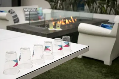 a group of glasses sitting on a table with a fireplace at The Kinney - Venice Beach in Los Angeles