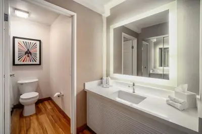 a bathroom with a sink and a toilet and a mirror at The Kinney - Venice Beach in Los Angeles