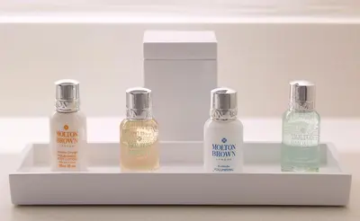three bottles of essential oils sitting on a shelf at Marina del Rey Hotel in Los Angeles