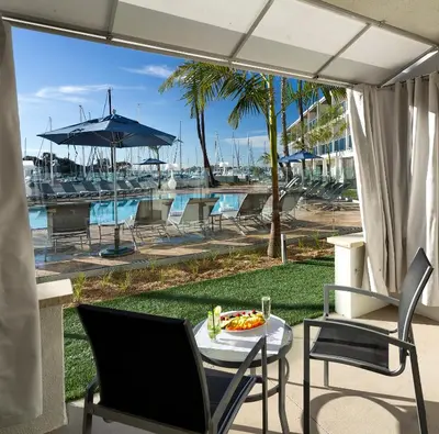 a patio with a table and chairs and a pool at Marina del Rey Hotel in Los Angeles