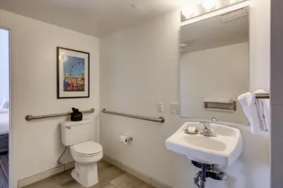a bathroom with a sink and a toilet and a mirror at Inn at Venice Beach in Los Angeles
