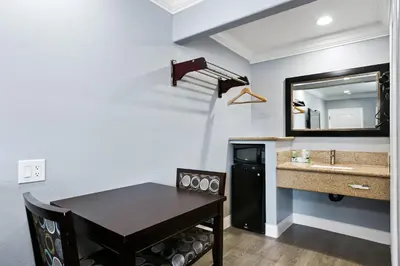 a bathroom with a table and a sink and a mirror at 3rd Avenue Inn in La Habra