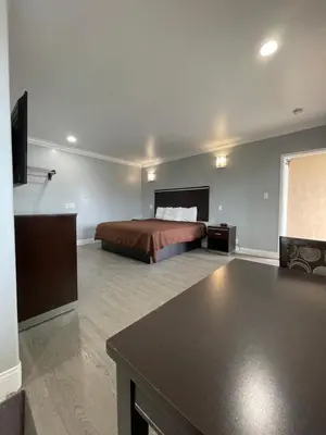 a hotel room with a bed and a table at 3rd Avenue Inn in La Habra