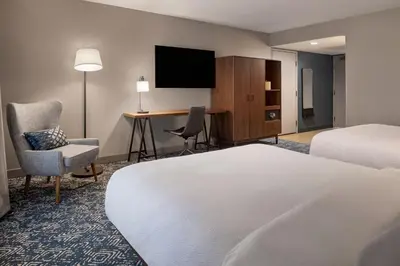 a hotel room with a bed and a desk at Four Points by Sheraton Bakersfield in Bakersfield