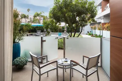 a patio with two chairs and a table at Shore Hotel in Los Angeles
