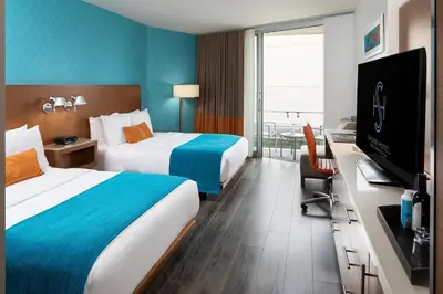 a hotel room with two beds and a flat screen tv at Shore Hotel in Los Angeles