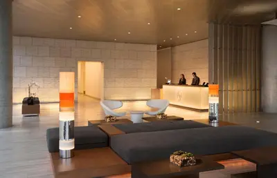 a lobby with a couch and chairs and a counter at Shore Hotel in Los Angeles