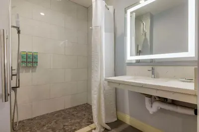 a bathroom with a sink and a mirror at Best Western Orange Plaza in Orange