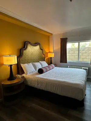 a bedroom with a bed with two lamps and a window at Howard Johnson by Wyndham Bakersfield in Bakersfield