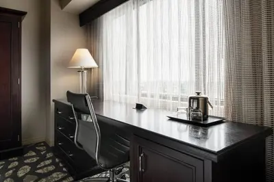 a desk in a room with a window with a tea kettle on it at Sheraton Garden Grove-Anaheim South in Anaheim