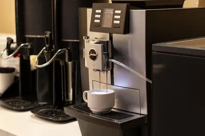 a coffee cup is being brewed in a coffee machine at Sheraton Garden Grove-Anaheim South in Anaheim