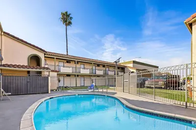 a swimming pool in front of a building at Rodeway Inn Santa Ana - Garden Grove in Santa Ana
