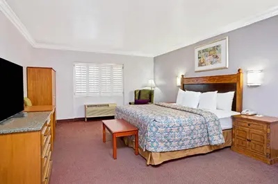 a hotel room with a bed and a television at Days Inn by Wyndham West Covina in West Covina