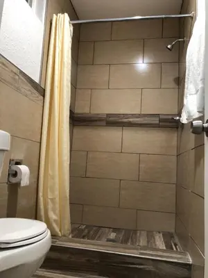 a bathroom with a shower with a toilet at Rosa Bell Motel - Los Angeles in Los Angeles