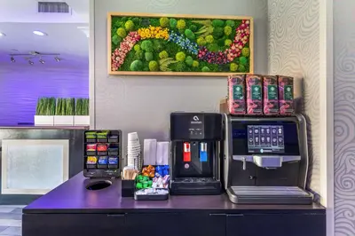 a coffee machine sitting on a counter in a coffee shop at Best Western PLUS Avita Suites in Torrance