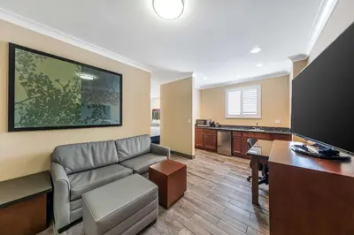 a living room with a couch and a desk at Best Western PLUS Avita Suites in Torrance