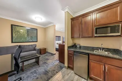 a kitchen and living room with a couch in a room at Best Western PLUS Avita Suites in Torrance