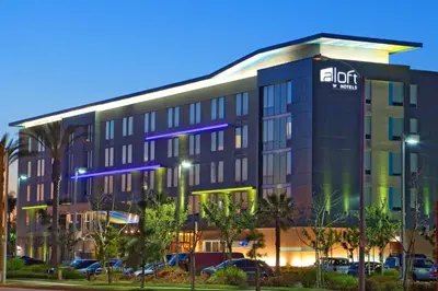 an office building with a lit up sign on it at Aloft Ontario-Rancho Cucamonga in Rancho Cucamonga