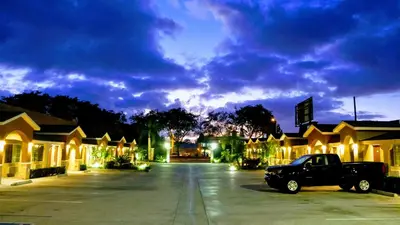 a truck parked in a parking lot at night at West Coast Inn Santa Ana in Santa Ana