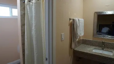 a bathroom with a shower and a sink at Holly Crest Hotel - Los Angeles, LAX Airport in Inglewood