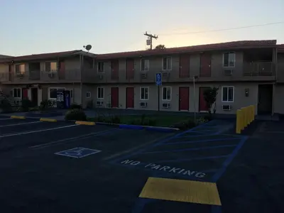 an empty parking lot in front of a building at Budget Inn LAX-Lawndale in Lawndale