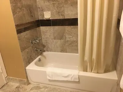 a bathroom with a bath tub with a shower curtain at Budget Inn LAX-Lawndale in Lawndale