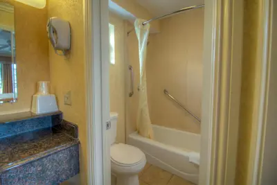 a bathroom with a toilet and a bath tub at Princess Inn in Westminster
