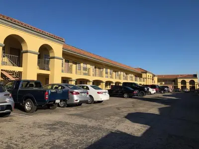 a group of cars parked in front of a building at Cali Inn in Carson