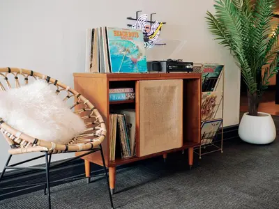 a room with a book shelf and a chair at Glendale Express Hotel Los Angeles in Glendale