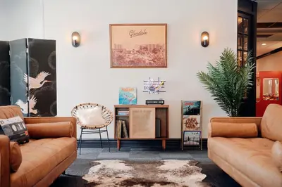 a living room with two couches and a table at Glendale Express Hotel Los Angeles in Glendale