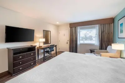 a hotel room with a bed and a flat screen tv at Best Western At Ventura Pier in Ventura