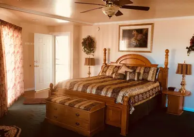 a bedroom with a bed and a ceiling fan at Giant Oaks Lodge in Running Springs