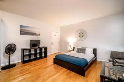 a bedroom with a bed and a tv and a couch at AIR Venice on the Beach in Los Angeles
