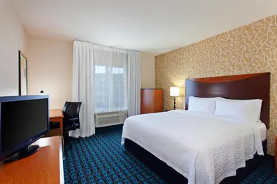 a hotel room with a bed and a flat screen tv at Fairfield Inn & Suites - Los Angeles West Covina in West Covina