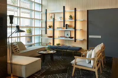 a living room with a couch and a table at Kimpton Hotel Wilshire by IHG in Los Angeles