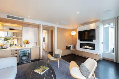 a living room with a table and a fireplace at Kimpton Hotel Wilshire by IHG in Los Angeles