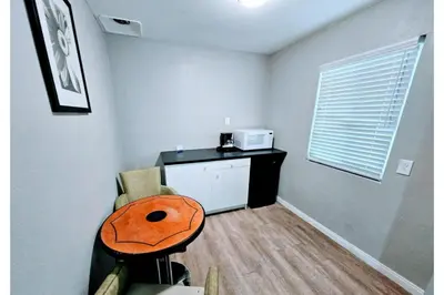 a small room with a table and a microwave at Hotel Ridgecrest An Extended Stay Studio in Ridgecrest