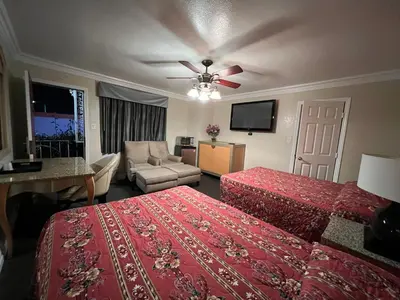 a hotel room with two beds and a ceiling fan at Flamingo Motel Oxnard in Oxnard