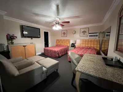 a living room with a couch and a bed at Flamingo Motel Oxnard in Oxnard