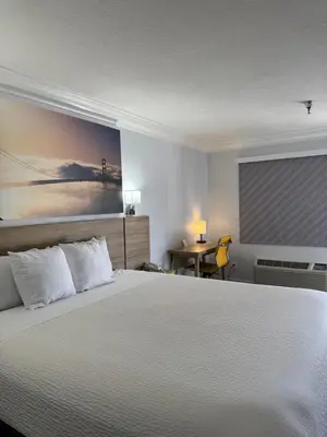 a bedroom with a large white bed and a window at Days Inn by Wyndham Near City Of Hope in Duarte