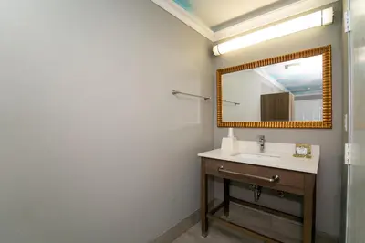 a bathroom with a sink and a mirror at Hollywood Palms Inns & Suites in Los Angeles