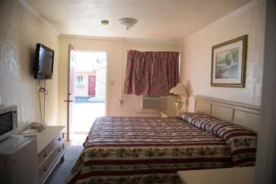a hotel room with a bed and a television at Boron Motel in Boron