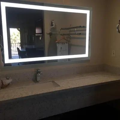 a mirror above a sink in a bathroom at Regency Inn in Norco