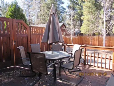 a table and chairs with an umbrella on a deck at Piece of Paradise in Big Bear Lake