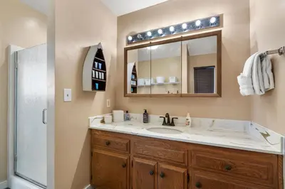 a bathroom with a sink and a mirror and a shower at Piece of Paradise in Big Bear Lake