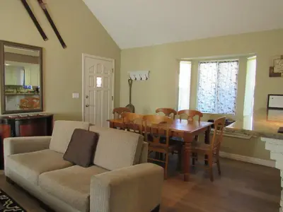 a living room with a table and a dining room at Big B's Den in Big Bear Lake