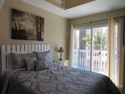 a bedroom with a bed and a large window at Big B's Den in Big Bear Lake