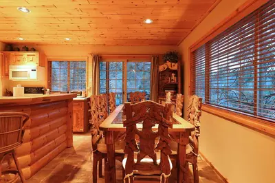 a dining room with a wooden table and chairs at Summit Ski-Inn Ski-Out in Big Bear Lake