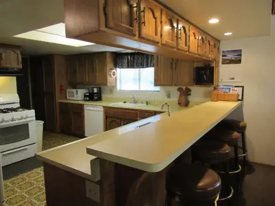 a kitchen with wooden cabinets and a counter top at Miller's Outpost in Big Bear Lake